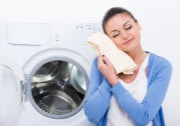 woman pulling soft towel from dryer
